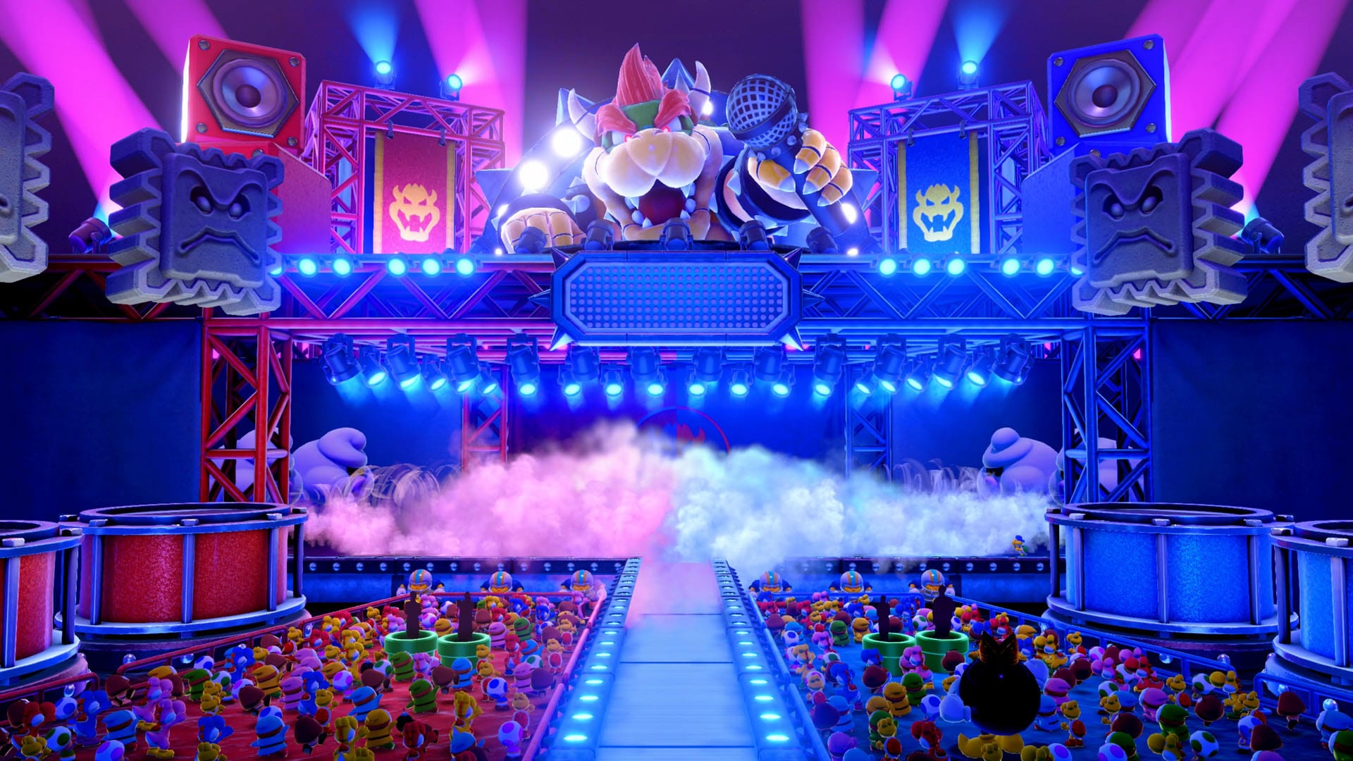 Bowser with a microphone appearing above a stage with a large crowd below