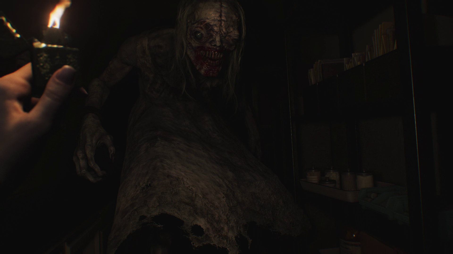 The toothy monster in Resident Evil Requieum approaching Grace from a first person perpective with a only lighter to defend herself.