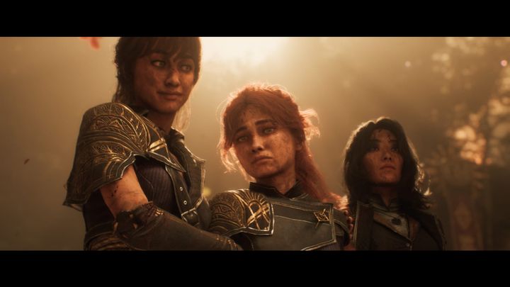 Three people standing up with a light coming through the trees behind them