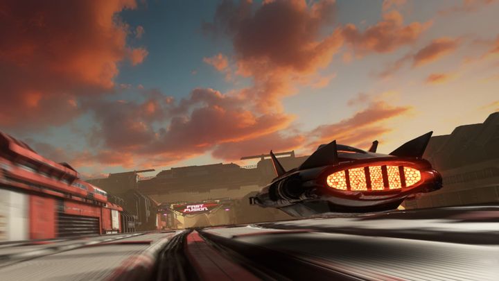 A futuristic hover car racing on a track, the clouds in the sky tinted with orange and red as the sun sets