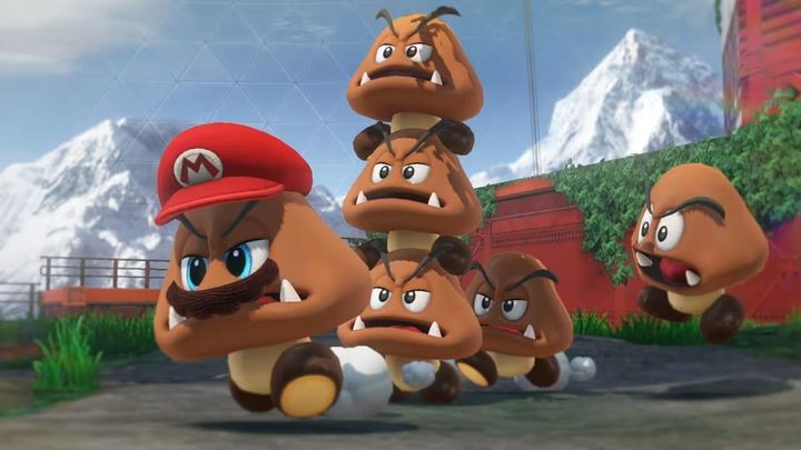Lots of goombas led by a moustached "goomba" wearing a red hat that says "M" on it.