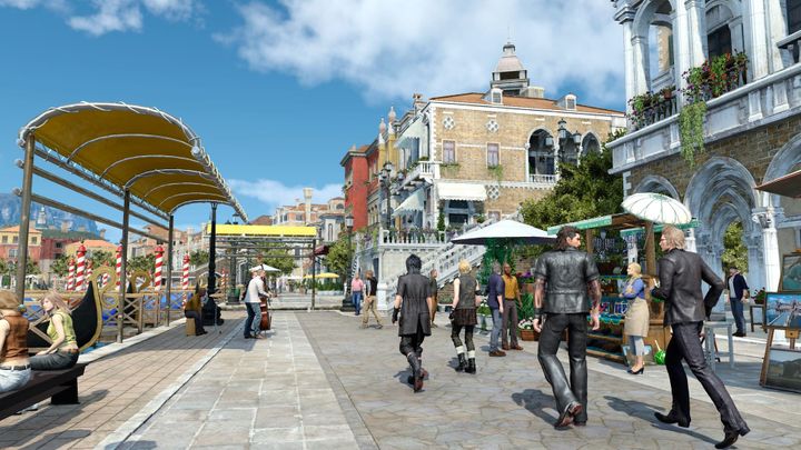 Shows Noctis, Prompto, Gladio, and Ignis enjoying a beautiful town by the water. 