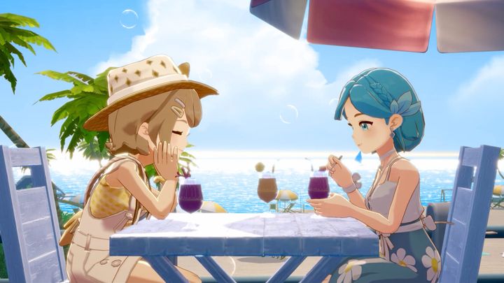 A brown haired young woman and a blue haired woman having drinks by the seaside on a sunny day