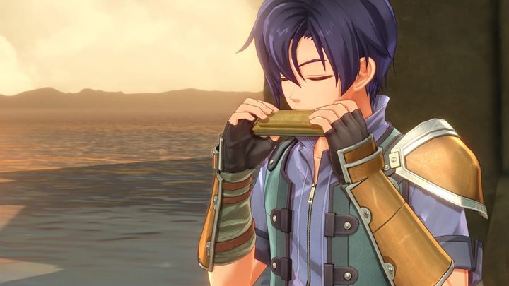 A black haired teenager playing a harmonica while the sun sets