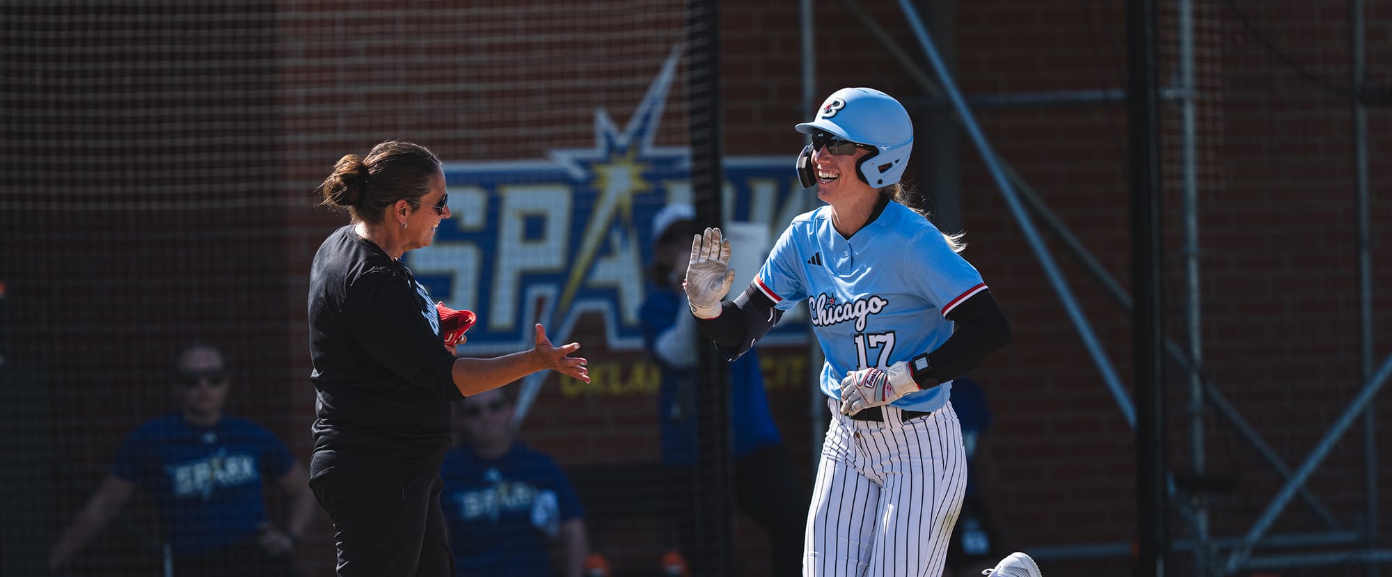 Chicago Bandits outfielder Skylar Wallace celebrates a home run with a coach