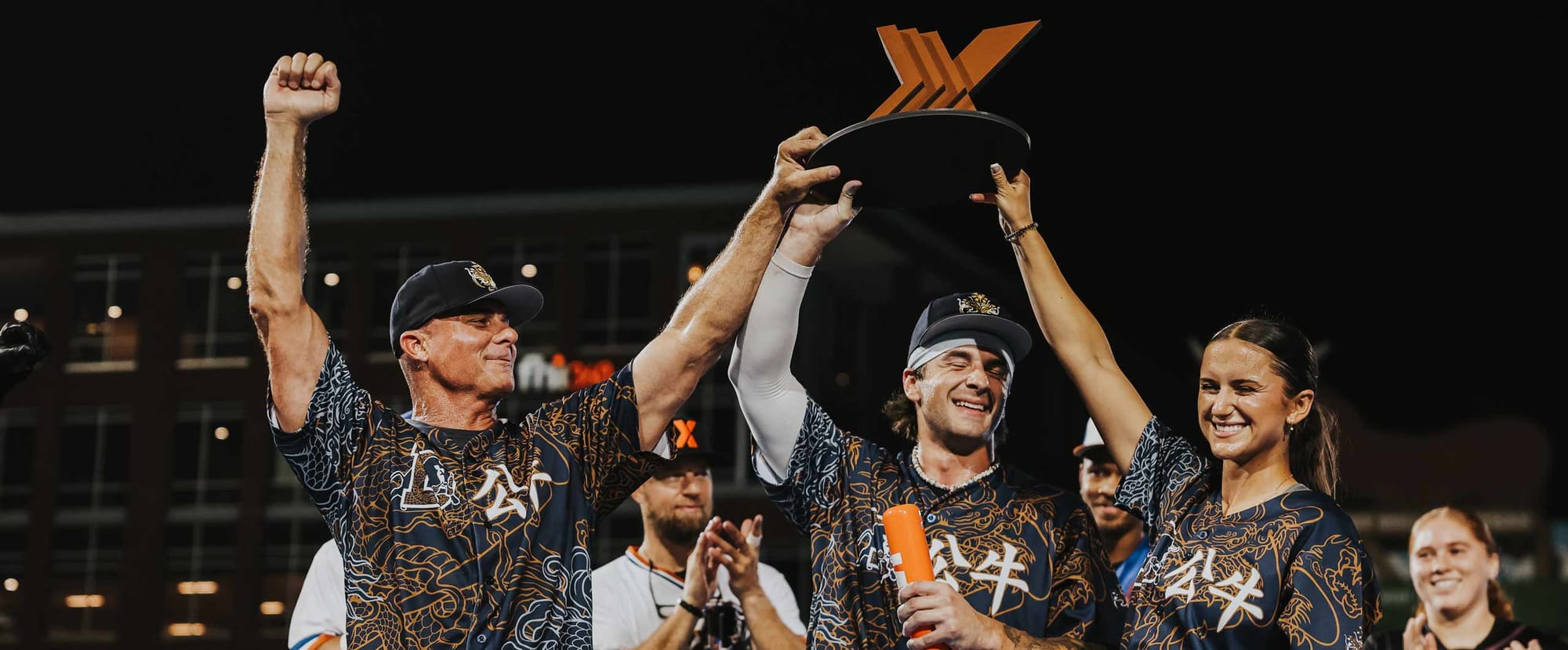Ana Gold and her Bull Dragons teammates hoist the MLBx Durham trophy at Durham Bulls Athletic Park