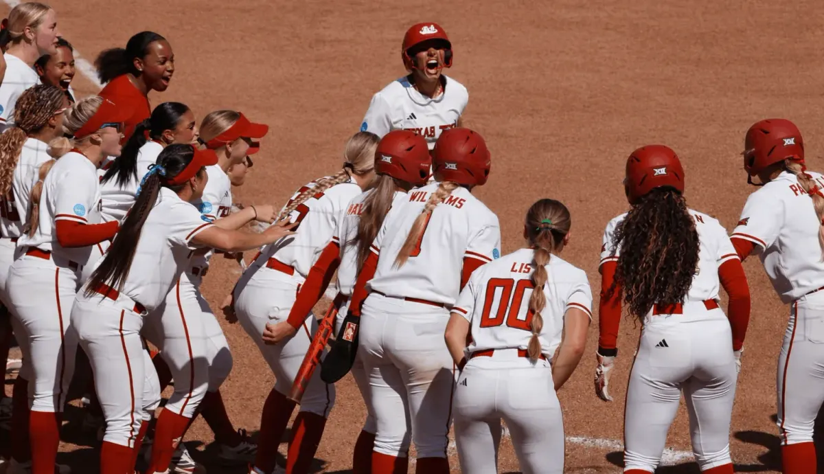 Texas Tech softball players celebrate at home plate after Lauren Allred's seventh-inning grand slam against Ole Miss