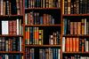 Close-up of library shelves filled with leather-bound books