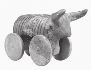 Ancient wheeled bull figurine with horns