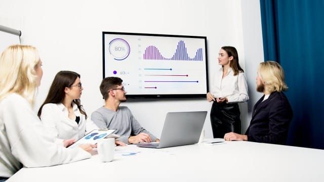 Photo of a woman doing a presentation at a meeting