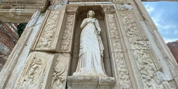 Photo of a statue of a woman in a stone wall