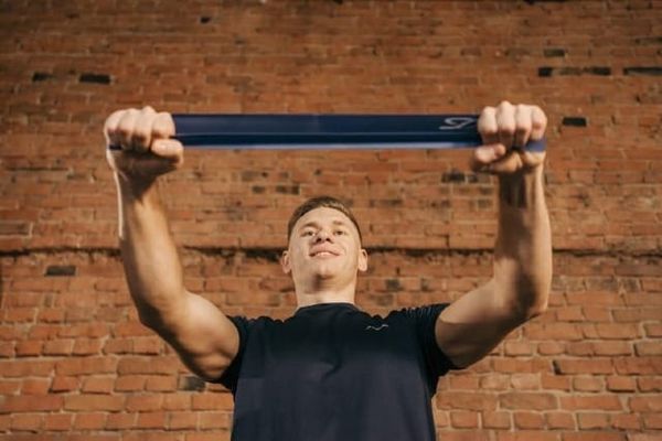 Photo of a man pulling a resistance band