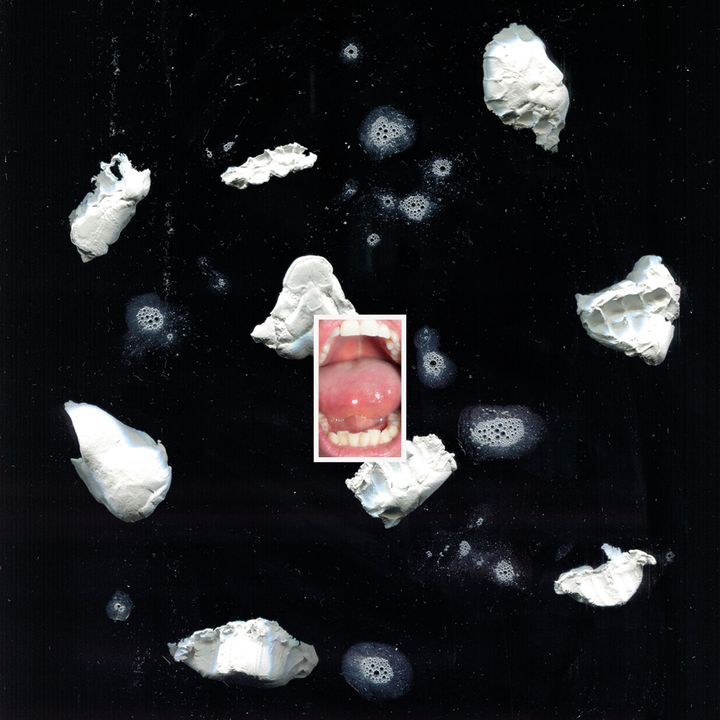 The artwork for Egg Meat's self-titled EP, with a picture of a mouth placed between chunks of plaster mould and spit.