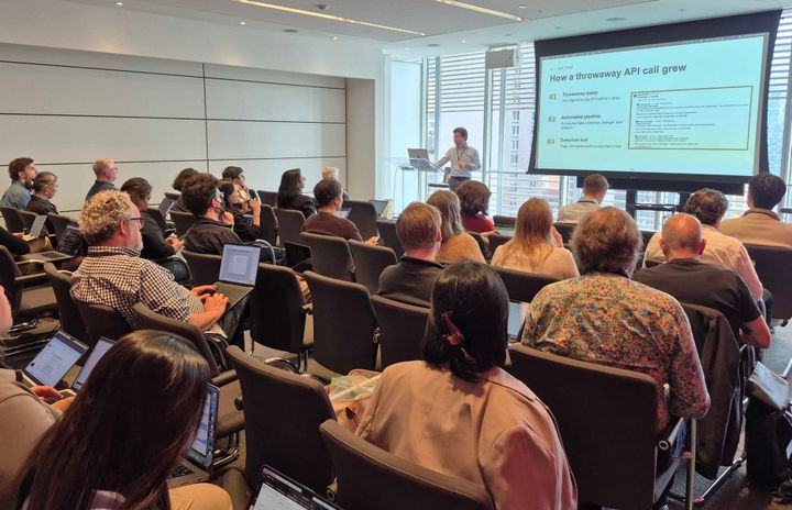 Avery Schmitz of CNN presents to a room of attendees working on laptops
