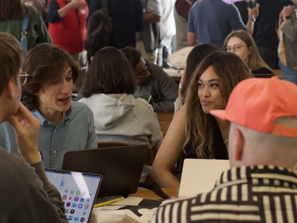 Participants working at tables during a Hacks/Hackers hackathon.