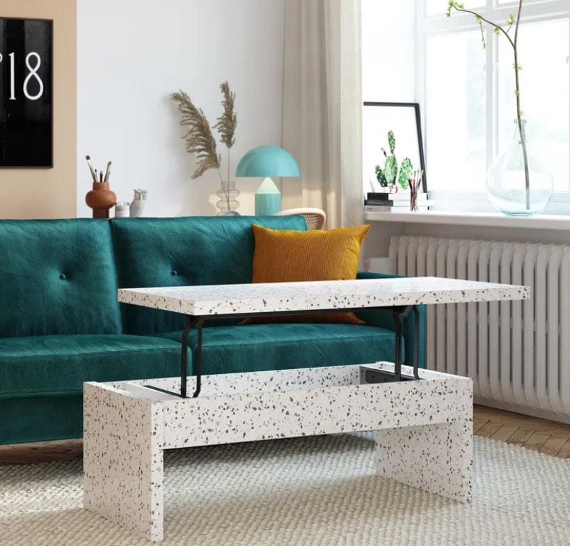 modern coffee table in faux terrazzo finish; taupe coffee table with graphite gray speckles beside a teal couch with a mustard yellow throw pillow; walmart and target coffee table deals