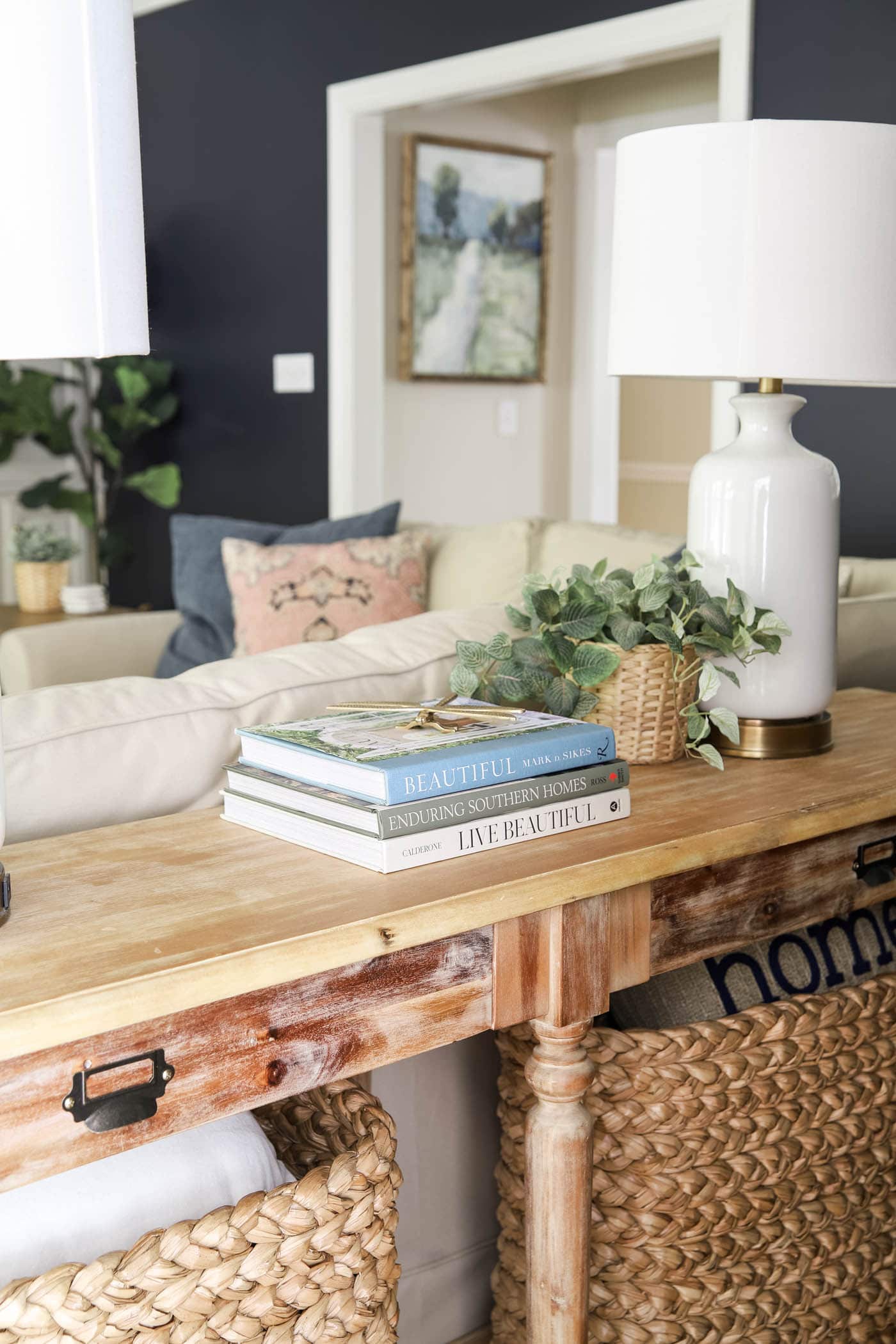 Books on a rustic wooden console table in a rustic coastal style living room