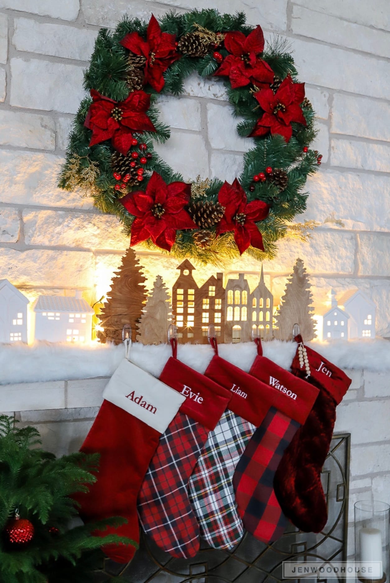 DIY Christmas stocking hangers holding five Christmas stockings hanging on the mantle