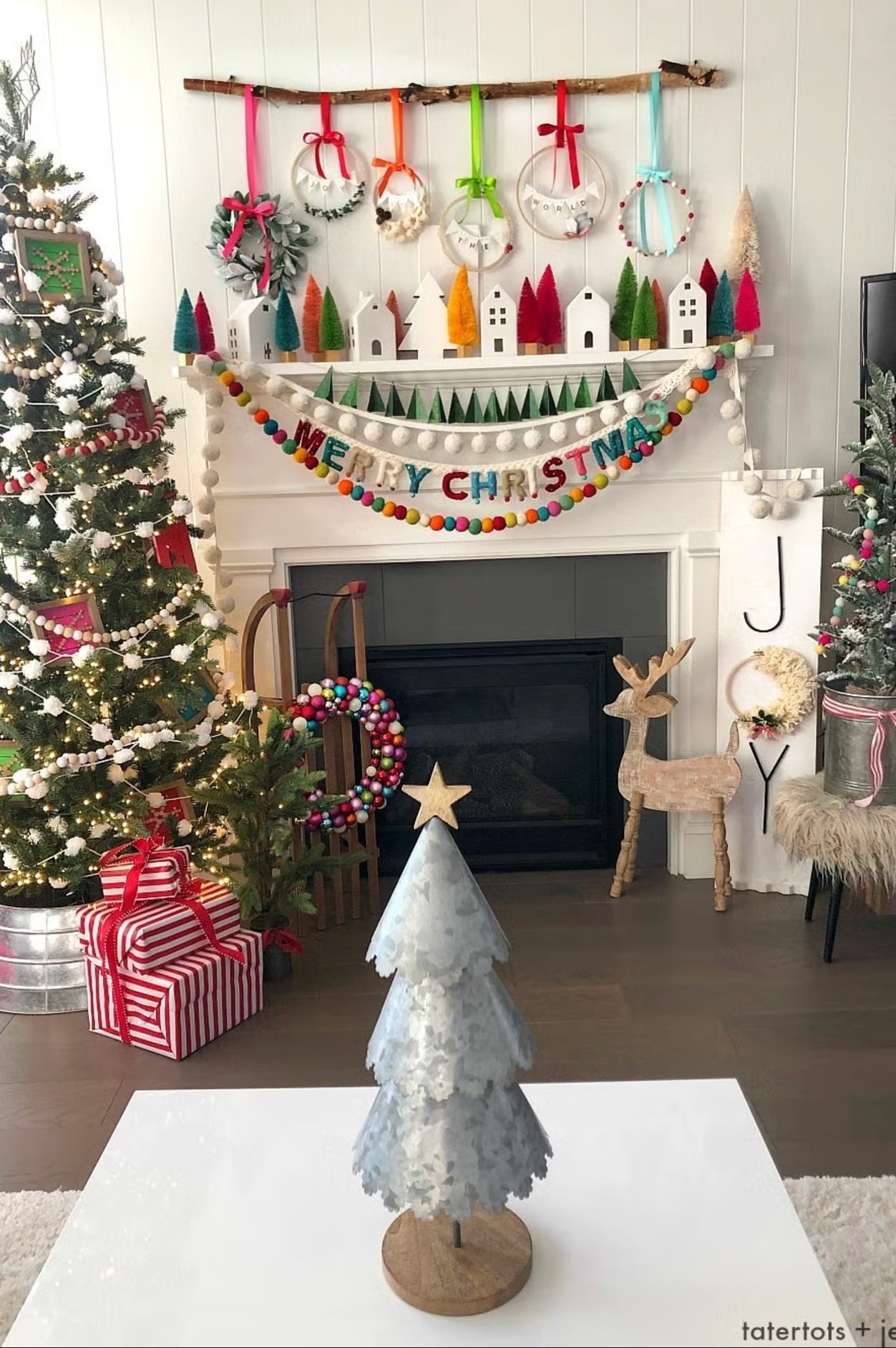 Colorful Christmas garlands on the mantel next to the Christmas tree; hanmade Christmas decorations throughout the room