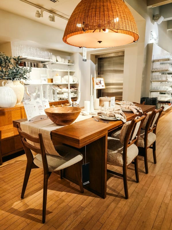 A dining room with a wooden table and chairs