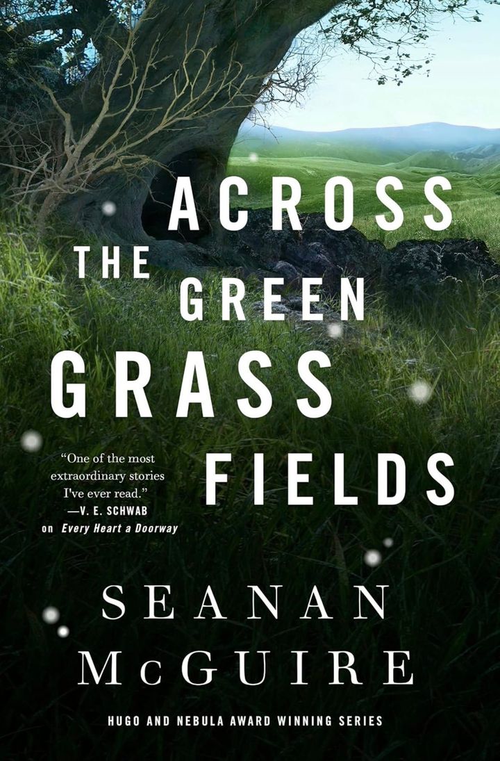 Across the Green Grass by Seanan McGuire book cover includes a tall grass field with a large hollowed out tree, suggesting a portal