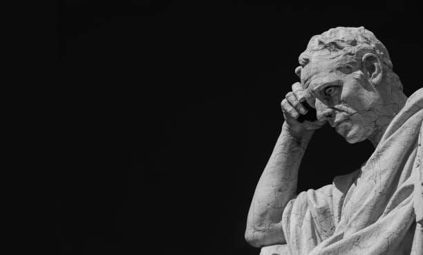 statue of a man pondering