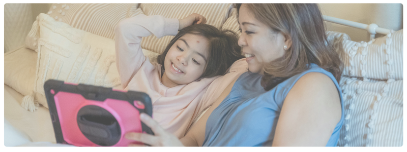 A mom and daughter co-engage on a tablet