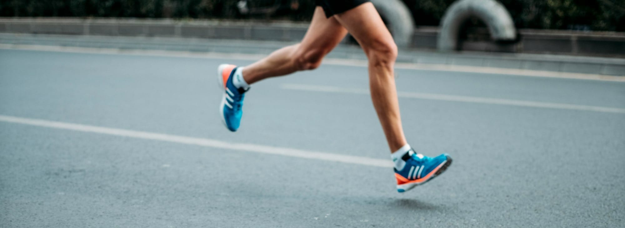 pair of blue-and-white Adidas running shoes
