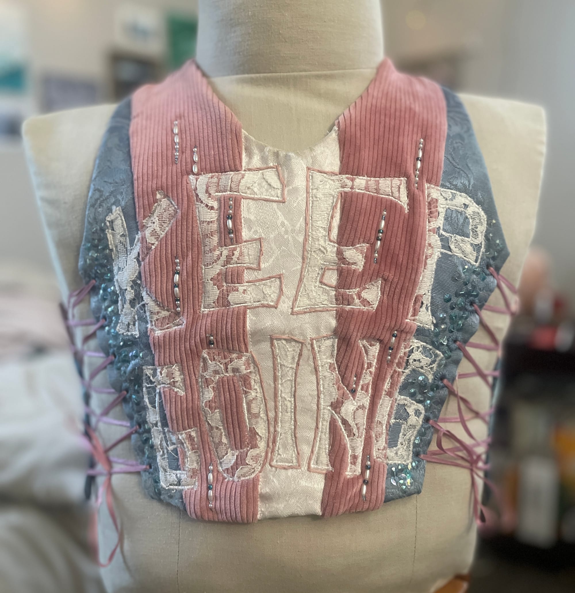 A binder with the trans pride colors and the words “Keep Going” on the front. 