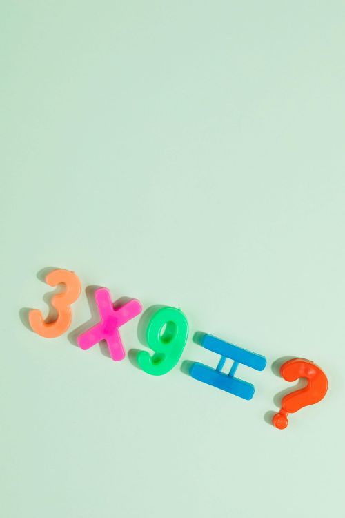 Colourful plastic numbers showing 3 x 9 = ?
