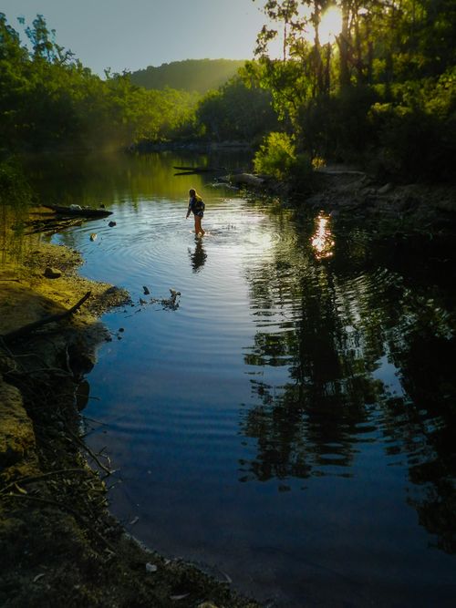 Child wading through a pond
