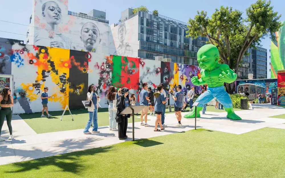 Miami Hotel Guide — Wynwood walls by day with colorful murals and a giant baby green Hulk; Wynwood things to do for street-art lovers.