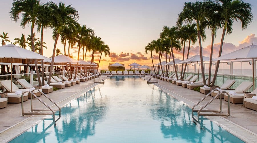 Rooftop pool and lounge at 1 Hotel South Beach near the Miami Boat Show, offering luxury ocean views and upscale accommodation.