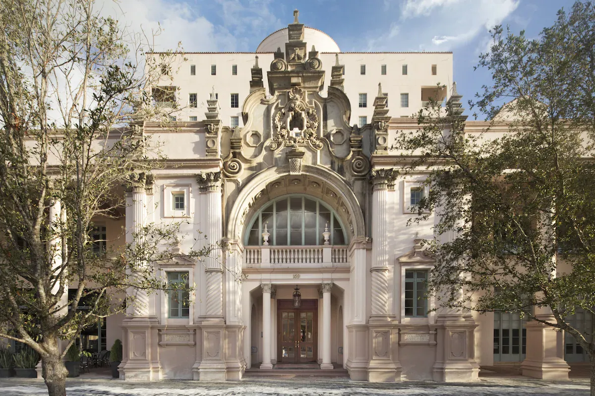 Exterior view of Hotel Colonnade, a boutique hotel in Coral Gables, showcasing its historic 1926 Mediterranean Revival architecture with grand columns and domed rotunda.