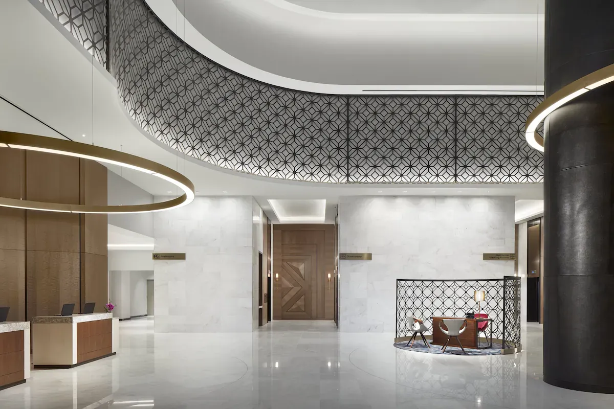 Lobby of Loews Coral Gables Hotel, a boutique luxury hotel in Coral Gables, featuring modern Mediterranean-inspired design with marble floors, elegant seating areas, and warm natural light.