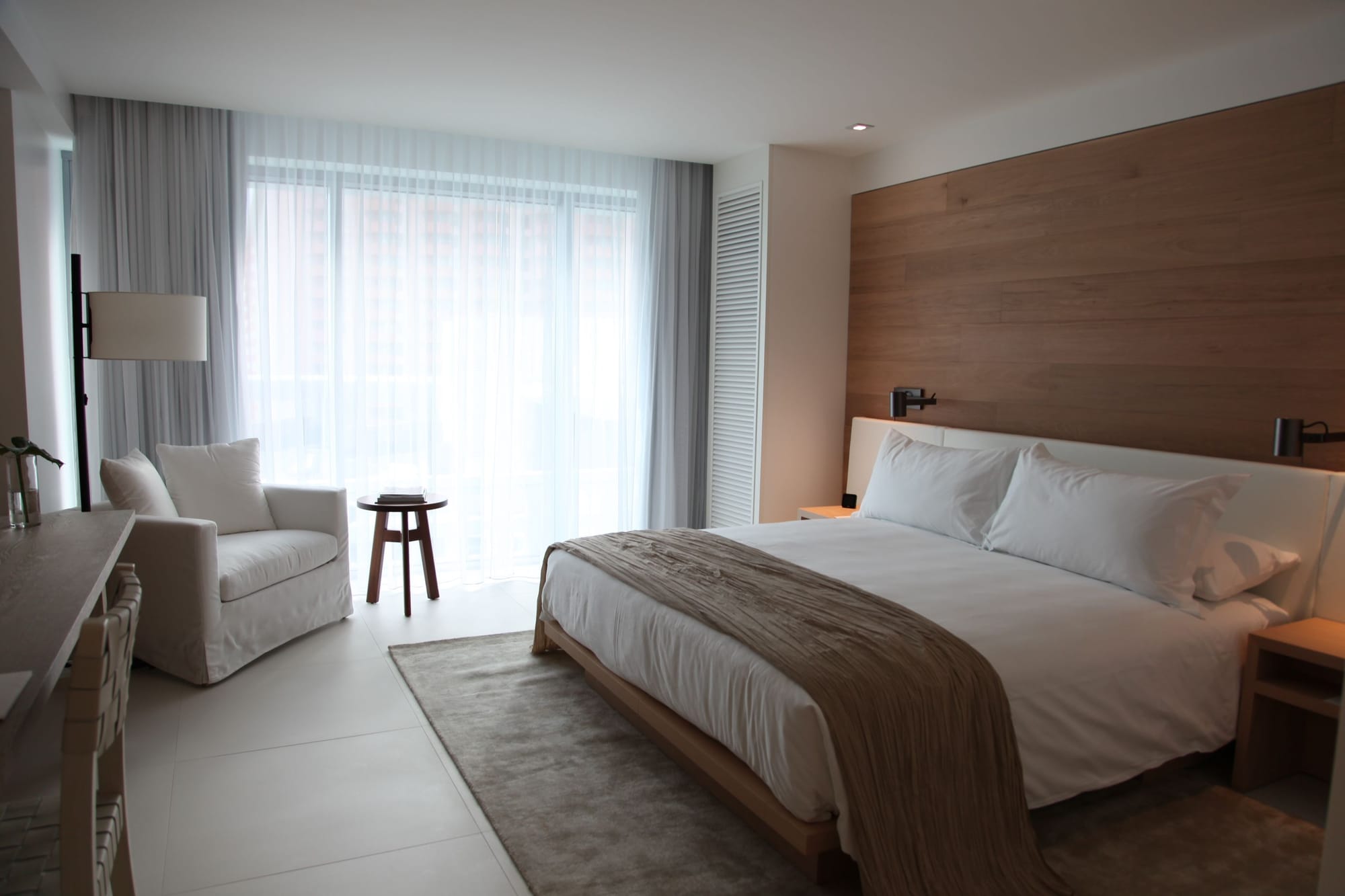 Standard King room at The Miami Beach EDITION with neutral decor and plush platform bed.