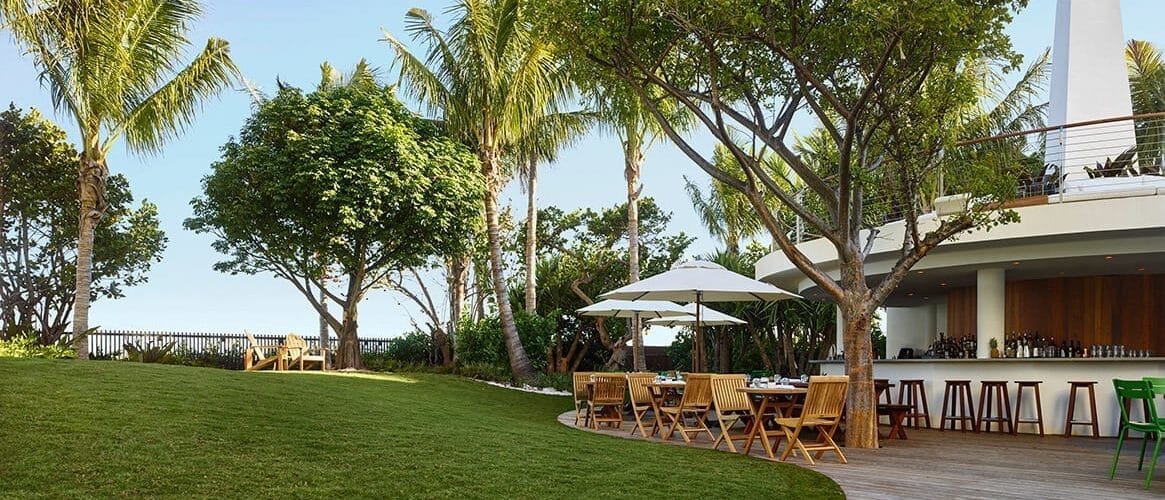 Tropicale at The Miami Beach EDITION—poolside outdoor dining under palms.