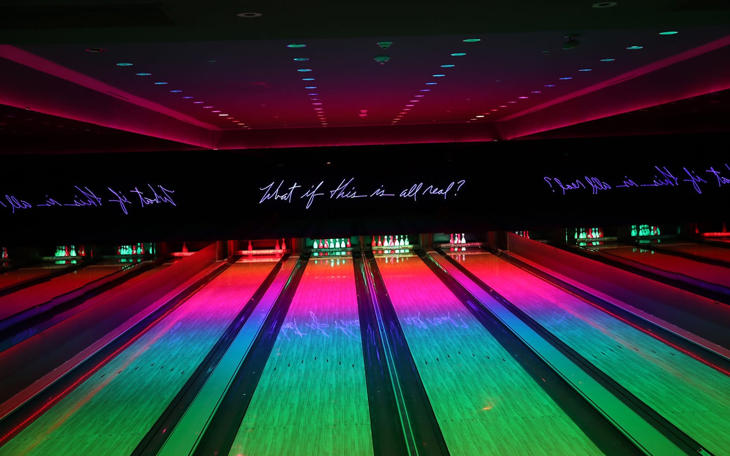 Basement Bowl at The Miami Beach EDITION—neon-lit bowling lanes with mirrored glow.