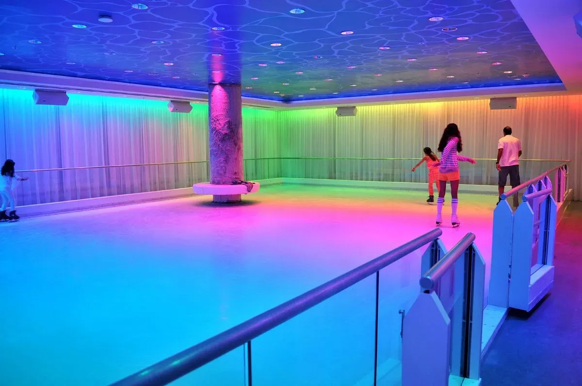 Basement Skate at The Miami Beach EDITION—neon-lit indoor ice rink with rainbow LEDs.
