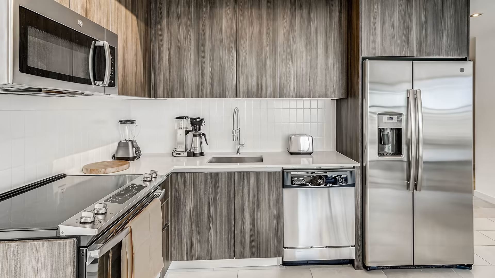 Family-friendly kitchen at Sentral Wynwood — full fridge, stove, and dining space