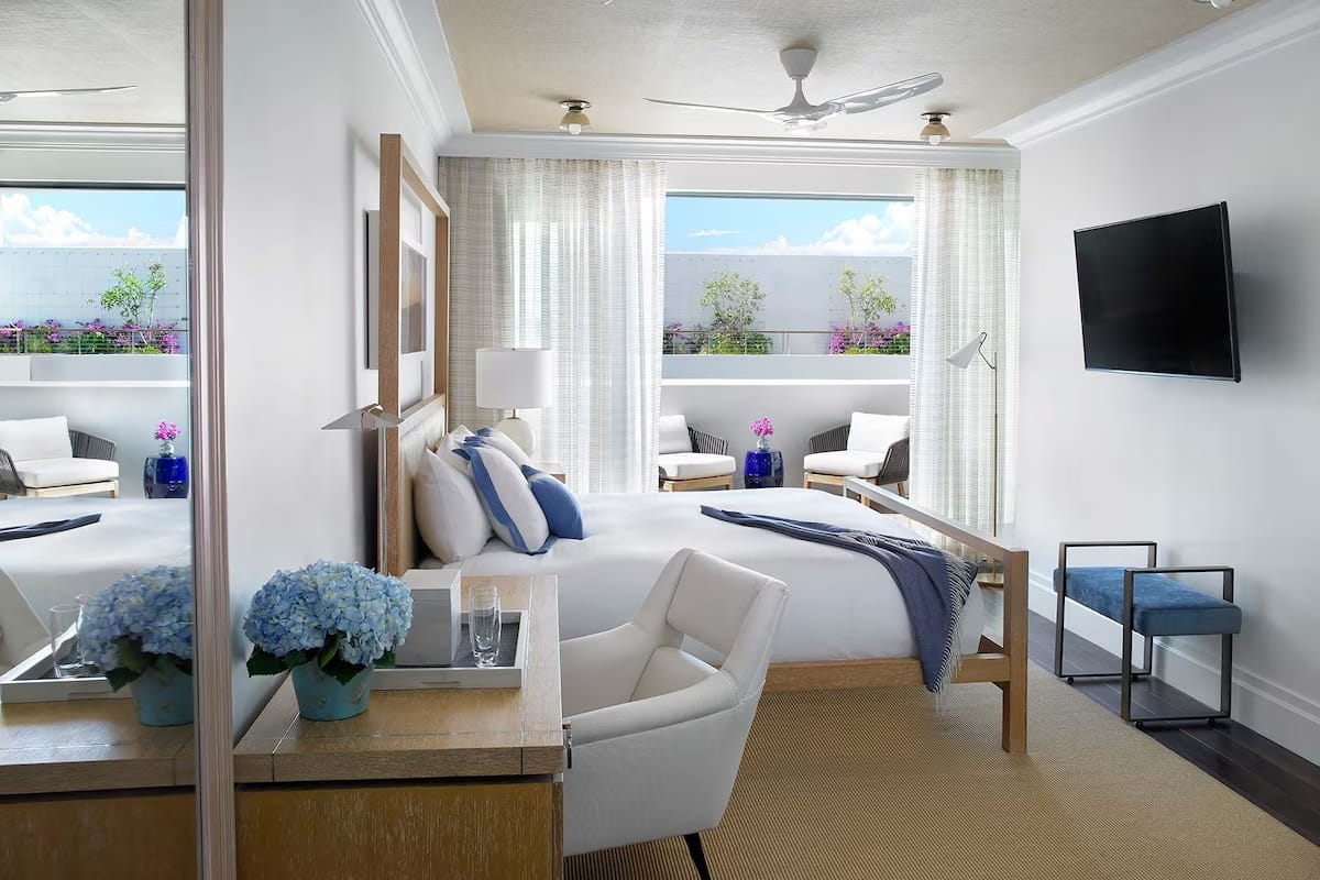 Quiet guest room with balcony at The Betsy Hotel in South Beach, Miami Beach Florida — comfortable hotel room for restful sleep.