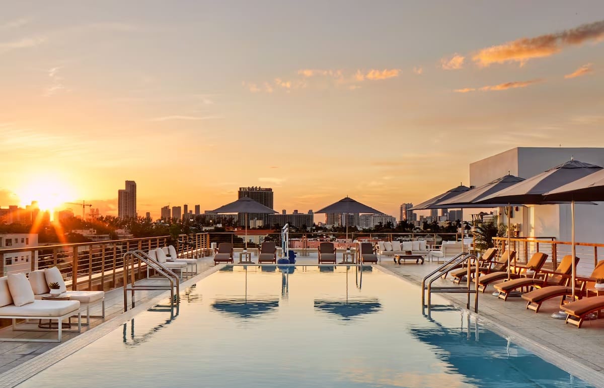 Rooftop pool at The Betsy Hotel in South Beach at sunset, Miami Beach Florida — beachfront hotel with outdoor pools and lounge space.