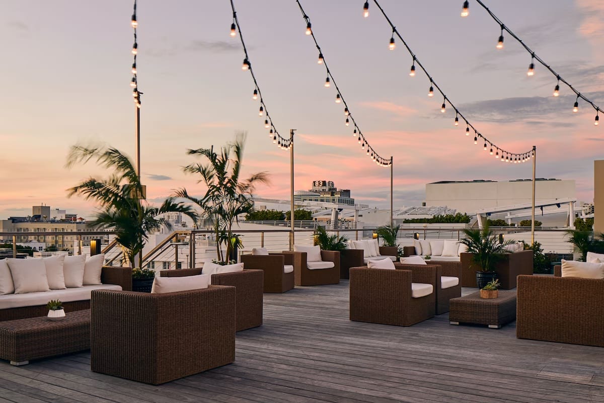Rooftop terrace at The Betsy Hotel in South Beach at golden hour, showing a calm luxury setting that makes it a top choice for first-time visitors to Miami Beach.