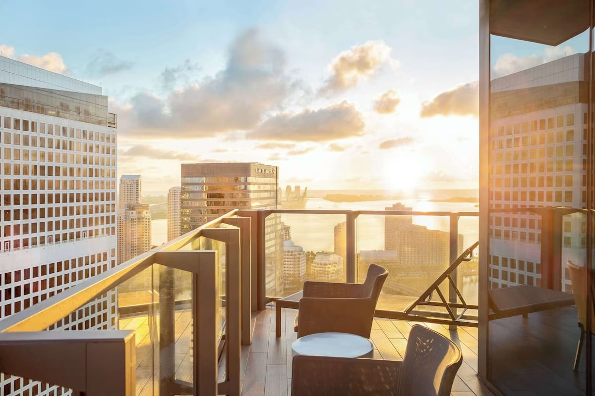 Sunset skyline view from a private balcony at EAST Miami in Brickell, overlooking downtown Miami and Biscayne Bay, showcasing modern luxury and walkable city views.
