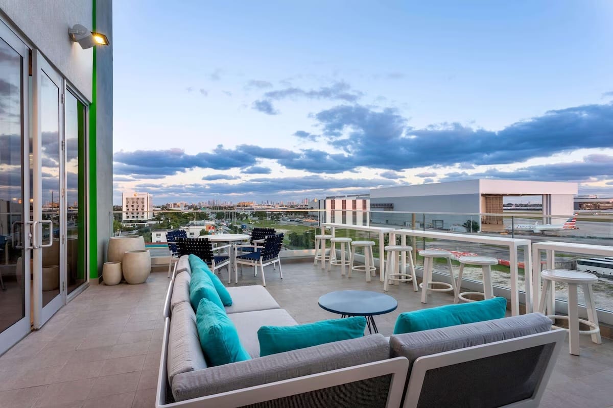 Rooftop outdoor lounge at Wyndham Garden Miami International Airport offering a calm setting and airport-area views for travelers before or after early flights