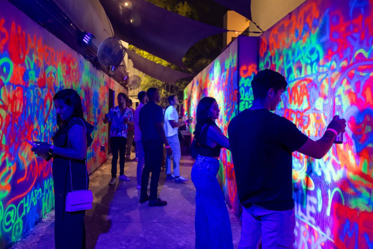 Wynwood Walls night graffiti experience Miami neon street art visitors painting walls