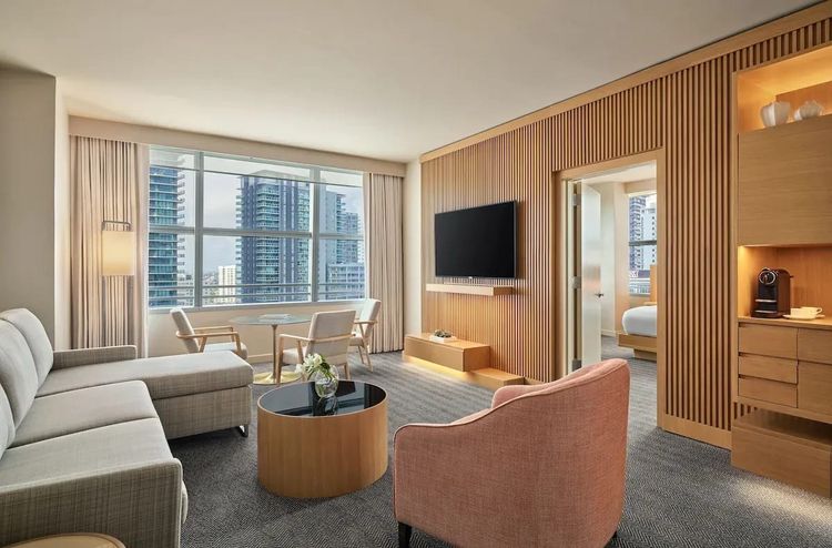 Hotel AKA Brickell extended stay suite living room with city view and modern seating