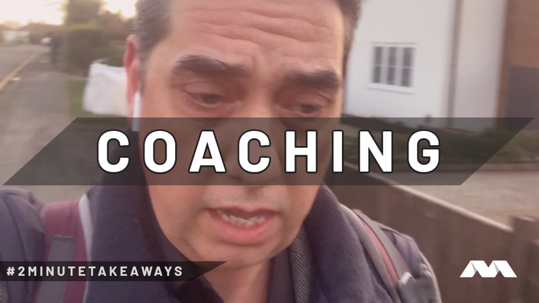 Elliott King films a close-up vlog selfie on a suburban street under the caption Coaching, for #2MinuteTakeaways.
