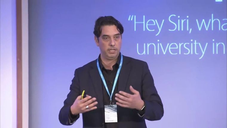 Elliott King presenting a slide reading Hey Siri, what is the best university, at the University of London in 2017