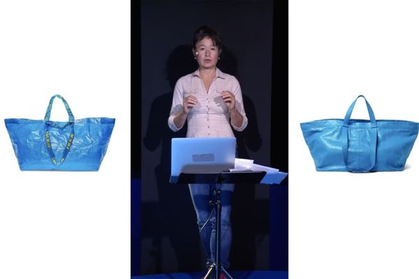 Una donna in piedi davanti a un leggio con un computer portatile. Ai lati, su due schermi, due borse di plastica.
